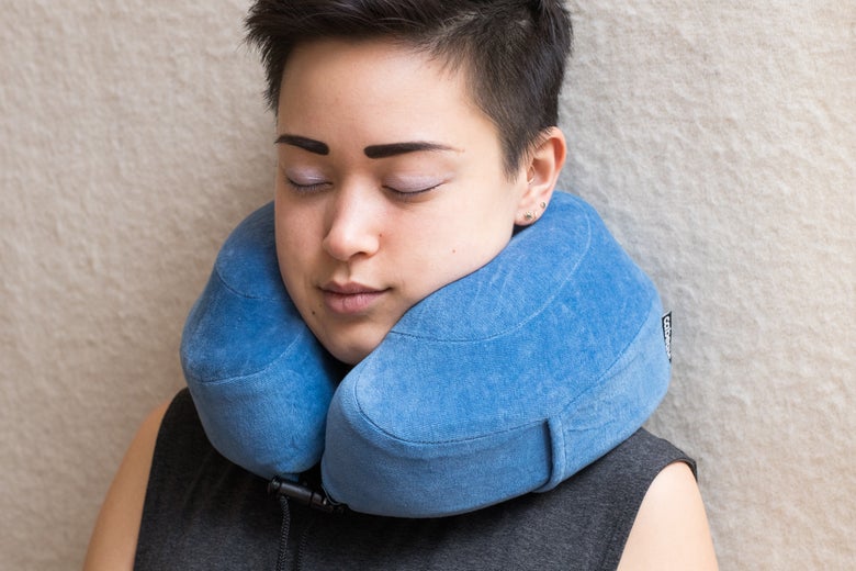 Woman wearing the Cabeau Evolution Pillow.
